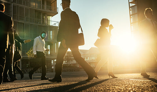 Business people walking on a busy street early in the morning