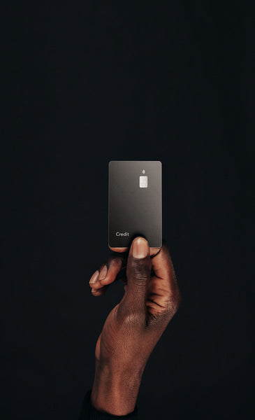 Modern Money: Man's hand holds up a contactless credit card in a studio