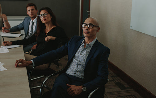 Business people listening to corporate briefing