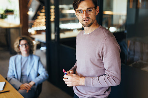Business man giving a presentation in a team meeting