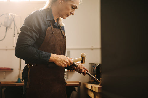 Professional female jeweler making jewelry
