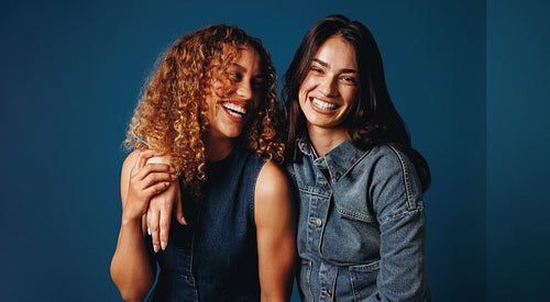 Confident friends smiling together in studio portrait