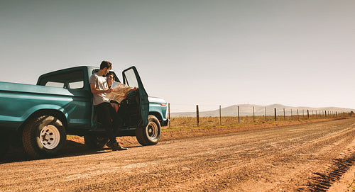 Couple on a road trip looking at map for navigation
