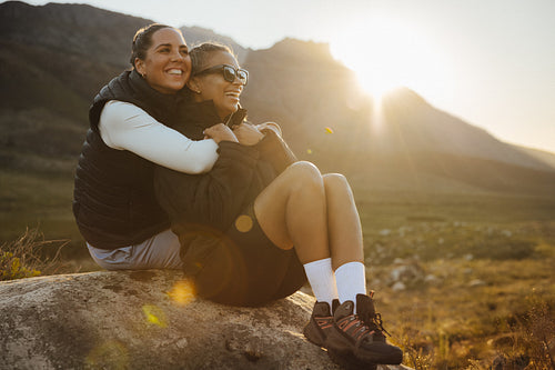 Two friends laughing in scenic outdoors