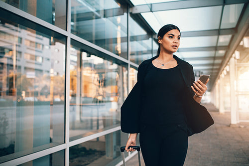 Businesswoman walking outside public transportation station
