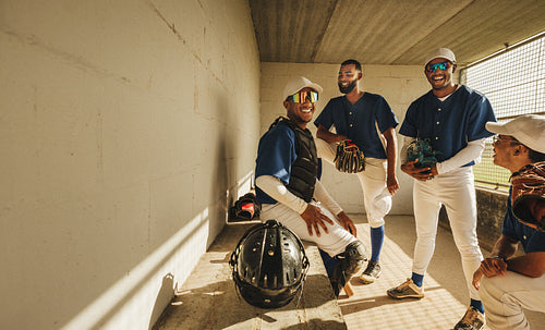 Baseball team in dugout enjoying camaraderie and preparation before game