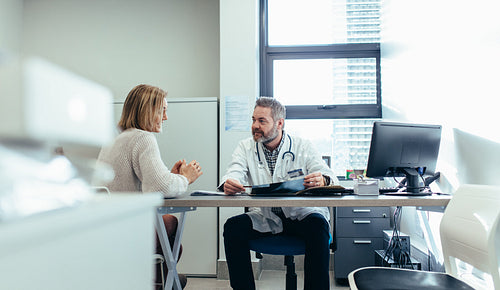 Doctor with patient during consultation in medical office
