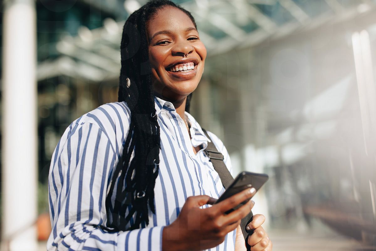 Portrait of a young black businesswoman smiling at the camera on her w ...