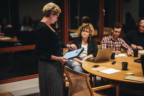 Businesswoman checking time during a meeting