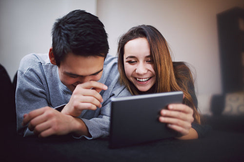 Happy young couple using tablet PC