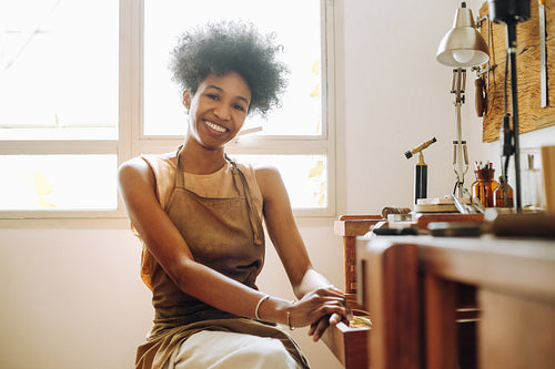 Happy female ornament designer at work