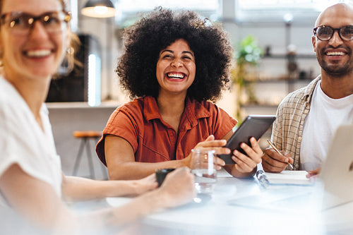 Business lunch in a cafe: Happy colleagues meeting in a coffee shop