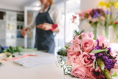 Bouquet in front with florist working in background