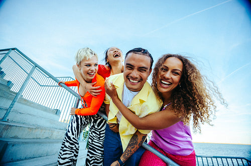 People gather as friends laugh together on outdoor steps in the city