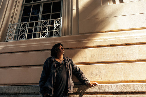 Homeless man looking up thoughtfully outdoors