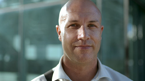 Mature man with bald head looking at camera
