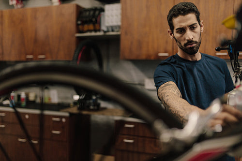 Bicycle mechanic assembling a bike in workshop