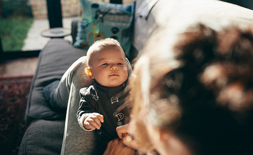 Baby sleeping on the legs of his mother