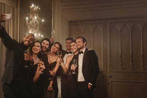 Group of friends posing for a selfie at gala night