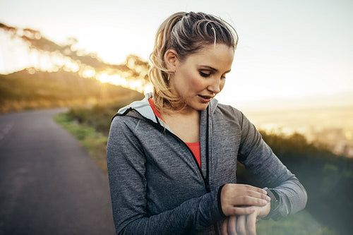 Fitness woman looking at her wrist watch