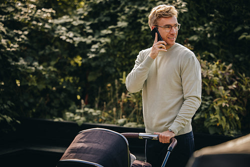 Man on paternity leave with baby stroller