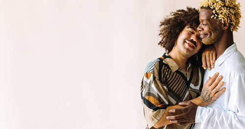 Two young male lovers embracing each other in a studio
