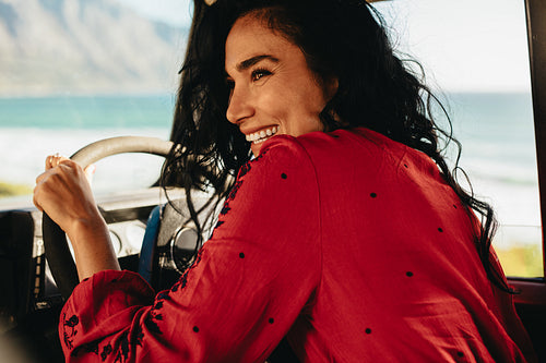 Smiling woman driving a car