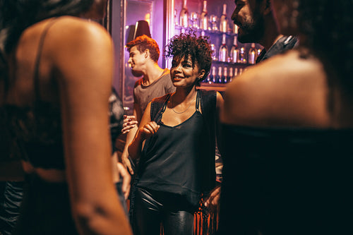 Young woman with her friends at nightclub