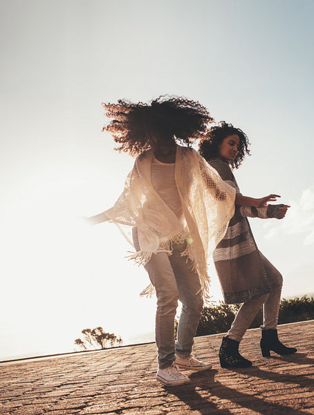 Friends dancing and enjoying on road trip