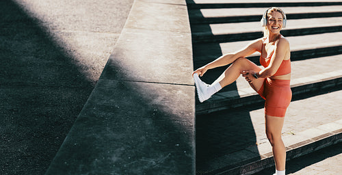 Happy sports woman taking a break from running outdoors
