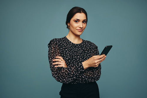 Young woman using a mobile phone in a studio