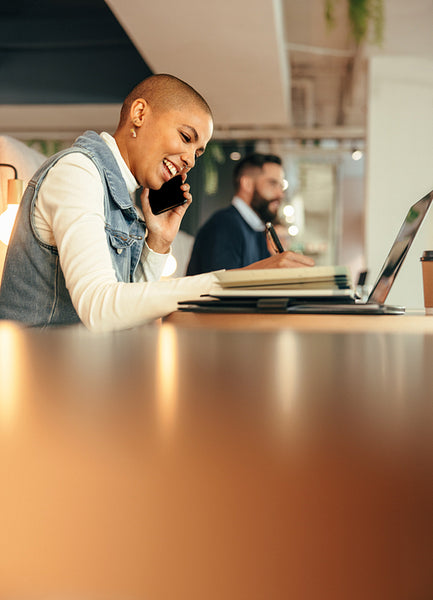 Businesswoman taking a phone call in a co-working space