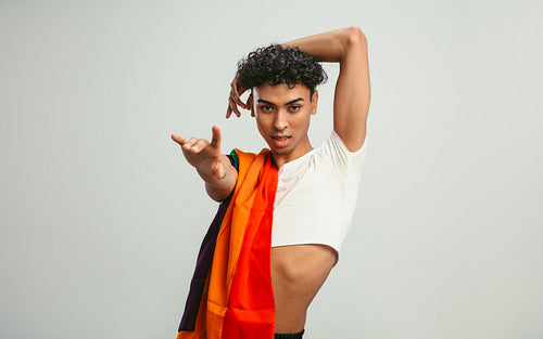 Gender fluid man posing with a lgbtq flag