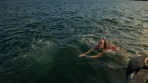 Woman swimming in the sea for an open water wellness ritual