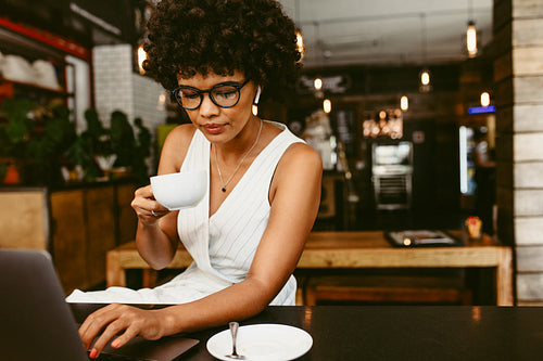 Woman sitting in cafe with a laptop
