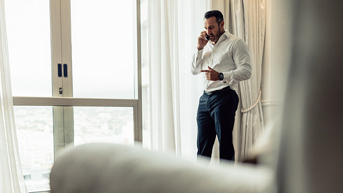 Businessman making a phone call from hotel room