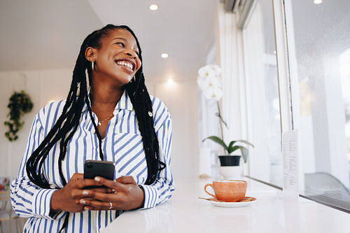 Young businesswoman smiling happily during her coffee break in a cafe