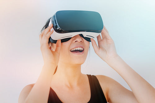 Smiling young woman using the VR goggles