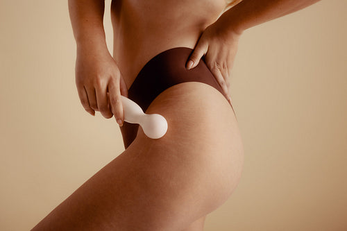 Woman holding a vibrator for intimate, feminine self-pleasure