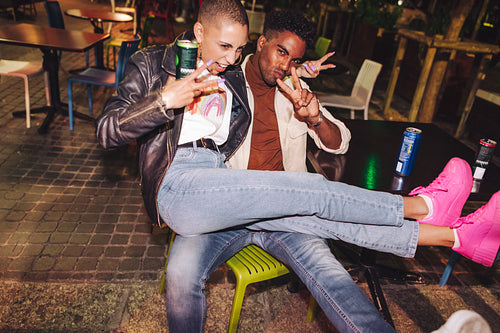 Best friends showing the peace sign at an outdoor restaurant
