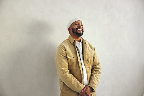 Modern businessman laughing happily in an office