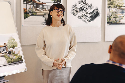 Young professional presenting architectural concepts in a design firm meeting