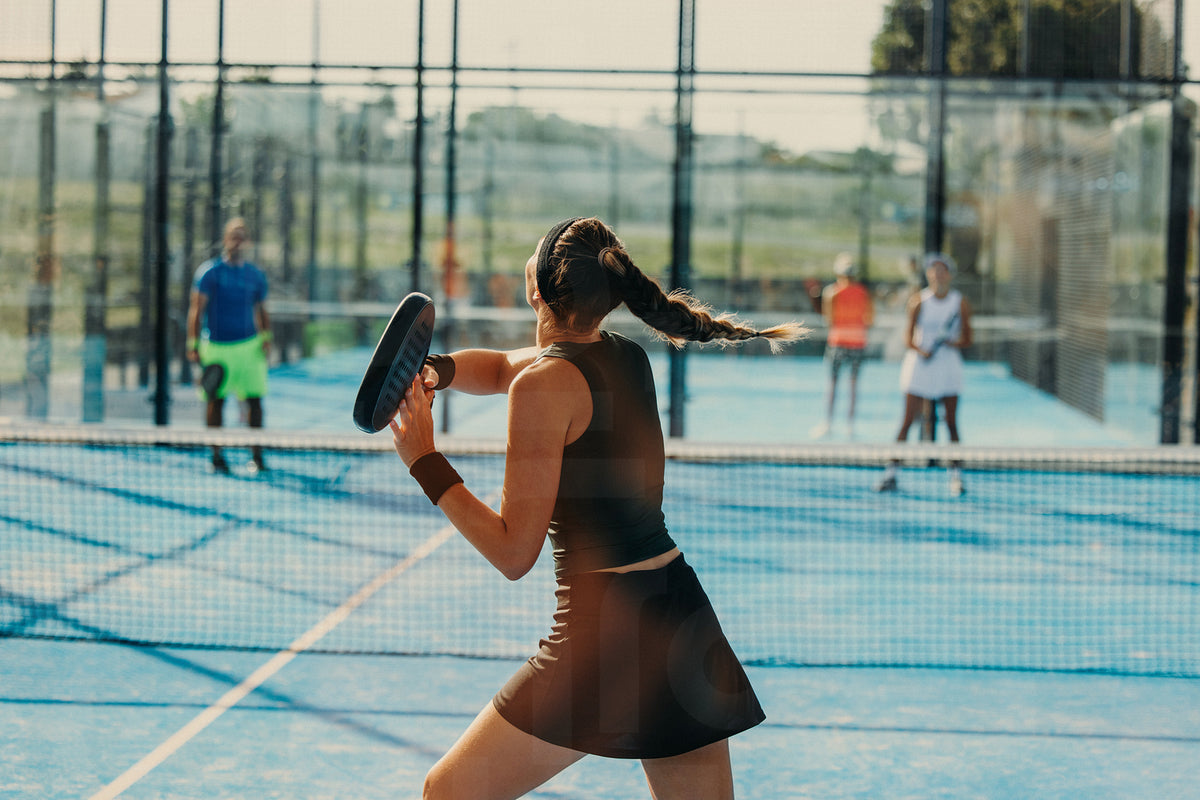 Young female athlete engaged in a padel match on the court – Jacob Lund ...