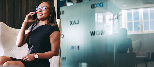 Young businesswoman speaking on a phone call at work