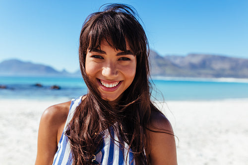 Young woman at the beach and smiling