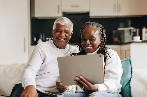 Retired couple having a video call on a digital tablet