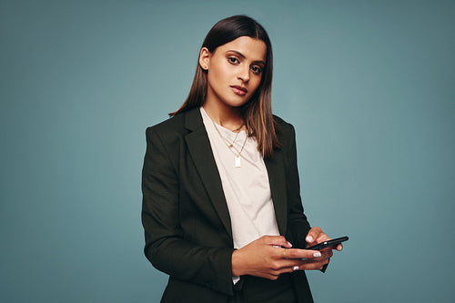 Young woman using a smartphone in a studio
