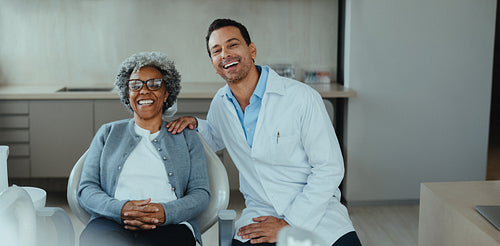 Dentist and senior patient smiling during dental consultation in a modern clinic