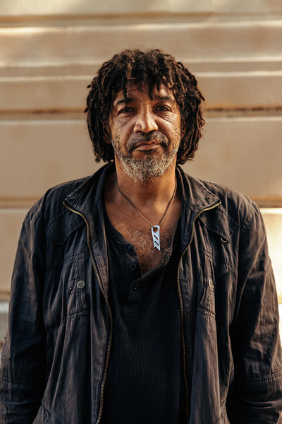 Middle aged homeless man looking at the camera outdoors