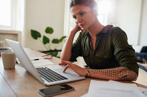 Woman working from home using laptop